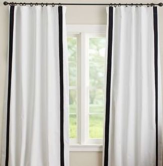 Adding trim to IKEA curtains to make them look more custom.